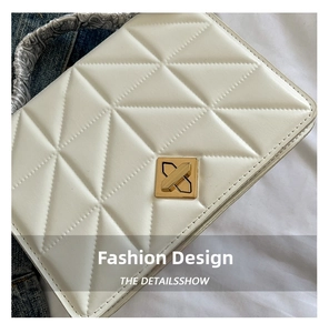 Détail du sac matelassé blanc en simili cuir avec fermoir doré et foulard à motifs enroulé