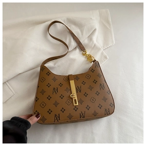 Detailed top view of brown hobo bag with gold metal buckle and leather chain strap