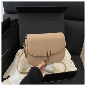 Beige crossbody bag with gold buckle in a premium gift box with white silk lining