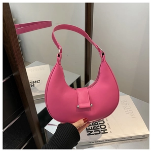Detail view of pink crescent hobo bag with silver buckle and smooth faux leather finish
