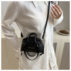 Detail view of the black lychee pattern leather mini crossbody bag with drawstring interior