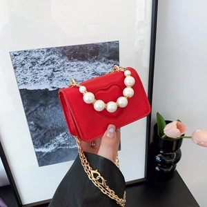Red heart-embossed mini shoulder bag with decorative white pearls and gold chain strap