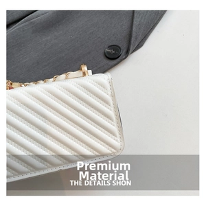 Close-up of white quilted leather texture with premium golden metal chain detail