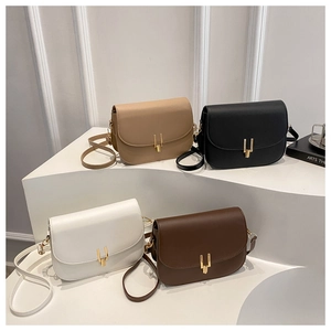 Minimalist crossbody saddle bags in four colors with gold metal buckles and adjustable straps
