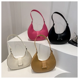 Minimalist crescent shoulder bags shown in four colors on a tiered white display stand
