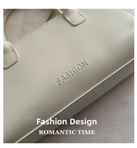 Detail of premium ivory leather texture with embossed fashion logo on tote bag