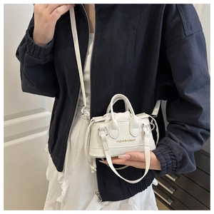 Close-up of white lychee pattern mini handbag with drawstring and gold logo detail