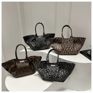 Collection of stylish leopard print tote bags in four colors on a white display