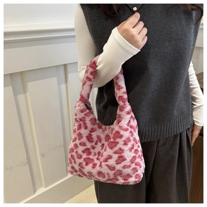 Detail der Handtasche aus rosa Kunstpelz mit Herzmuster und weicher Plüschtextur
