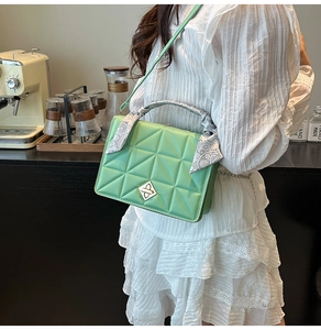 Quilted light green crossbody bag with gold buckle and silk scarf handle detail