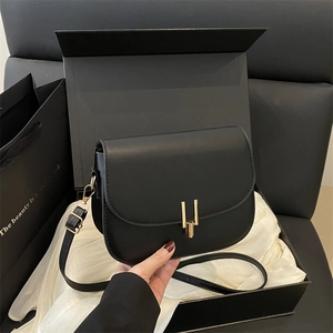 Minimalist black leather crossbody bag with gold H buckle in premium gift box set