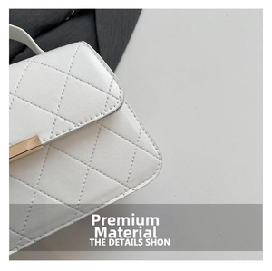 Close-up of white quilted faux leather texture and gold rectangular metal buckle detail