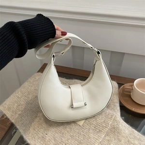 Chic white half-moon crossbody bag with silver buckle and adjustable shoulder strap