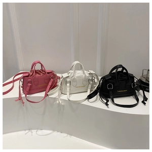 Detailed comparison of mini drawstring bucket bags in pink, white, and black leather finish