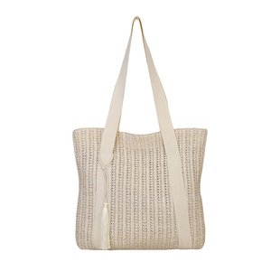 Stylish beige straw woven tote bag with wide straps and decorative side tassel charm