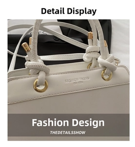 Detail of white leather handbag featuring a knotted handle and embossed fashion logo
