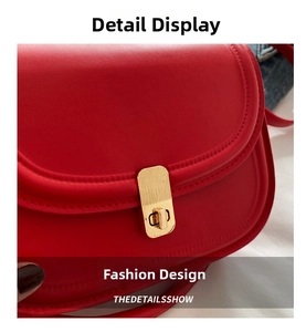 Detail view of red synthetic leather handbag featuring a golden rectangular metal twist lock