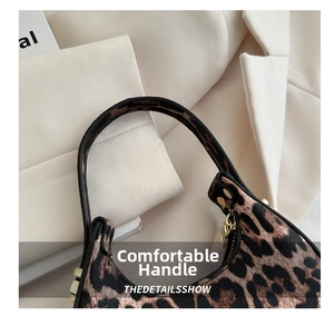 Gros plan du sac croissant léopard avec texture litchi et rivets métalliques dorés