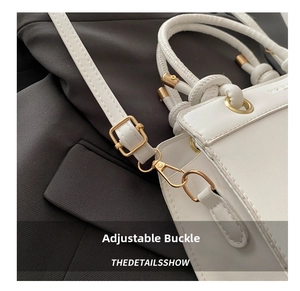 Macro detail of adjustable golden buckle and white leather strap on women's handbag