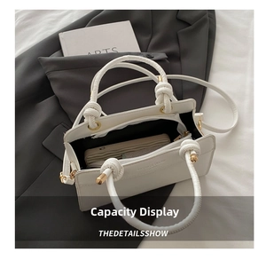 Detailed interior view of a white leather tote bag with matching wallet and shoulder strap