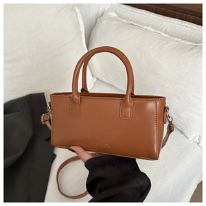 Detailed macro view of the brown synthetic leather texture and FASHION embossed logo