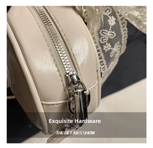Macro view of silver metal zipper and cream leather texture on the vintage handbag