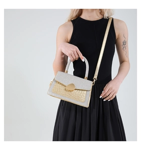 Detail of evening bag showing silver glitter flap and gold crocodile texture finish