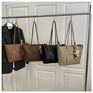 Detailed display of vintage large tote bags in four colors with decorative silk scarves