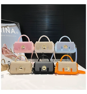 Close-up of stylish mini square bags in six pastel colors with large round metal buckles