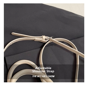 Detail of adjustable cream leather shoulder strap with polished silver metal buckle
