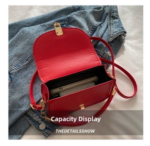 Internal view of open red faux leather crossbody bag showing phone and wallet storage