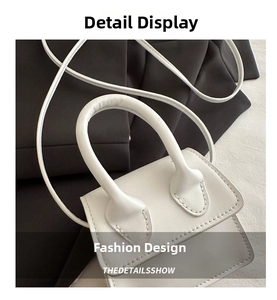 Detail shot of mini white PU leather handbag featuring fine stitching and curved handle
