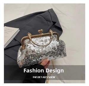 Detailed shot of silver sequin evening clutch with gold ball clasp and chain strap