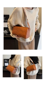Detail einer braunen Zylindertasche mit geometrisch gemustertem Web-Schultergurt