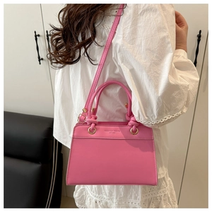 Pink faux leather trapezoid handbag featuring Fashion Trend 1996 text with shoulder strap