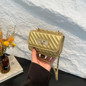 Golden chevron quilted mini chain crossbody bag with metallic turn-lock closure