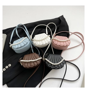 Detail of shell-shaped mini bags in five colors with quilted texture and pearl chain decor