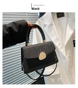 Detail view of black sequin and crocodile pattern flap bag with gold pebble twist lock
