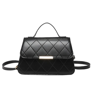 Minimalist black quilted crossbody bag with a sleek gold metal buckle for women