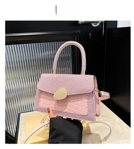 Detailed view of pink sequin crossbody bag with croc-embossed leather and gold clasp