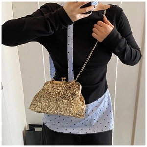 Detailed view of the gold sequined seashell crossbody bag with chic metallic chain strap