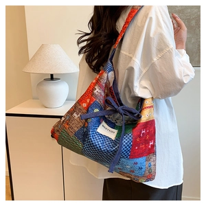 Detail of bohemian patchwork tote bag featuring vibrant patterns and brand tag