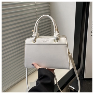 White trapezoid PU handbag detail with knot handle and Fashion Trend printed logo