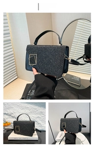 Detail of black glitter handbag featuring double gold geometric buckles and texture