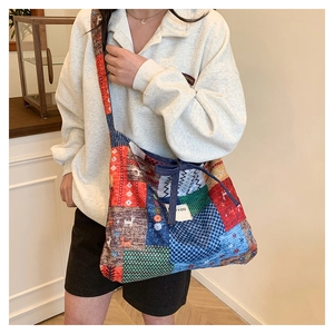 Detail of colorful patchwork tote bag with ethnic prints and drawstring closure
