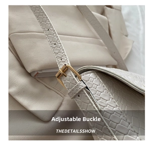 Close-up of golden metal buckle and white animal texture on adjustable shoulder bag