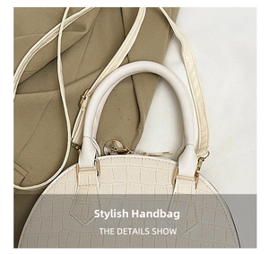 Close-up of white shell bag with crocodile texture, gold zipper, and sturdy top handle