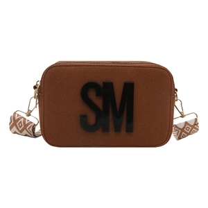 Brown frosted leather camera bag with SM logo and geometric jacquard wide strap