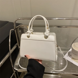 White trapezoid handbag in synthetic leather with tubular handles and shoulder strap