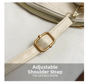Detail of adjustable cream white shoulder strap with gold metal buckle and lobster clasp